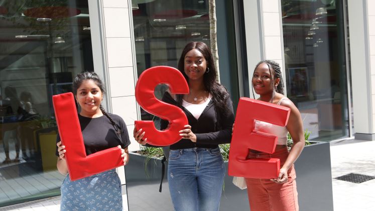 students on campus with LSE sign 747x420