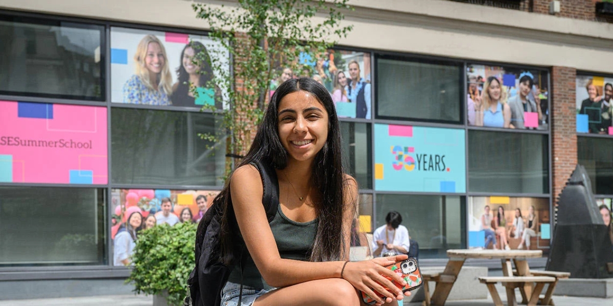 A student sat outside LSE Library